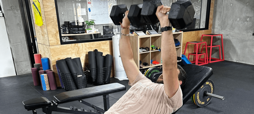 Man lifting weights in gym, weight training by professional strength trainers, reliable strength coaching Melbourne - Run Ready