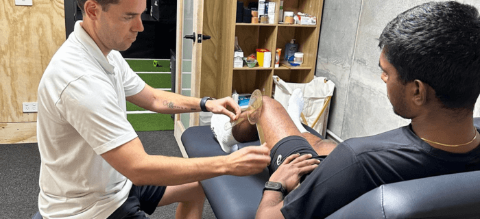 Sports Physiotherapist, Richie Lynch, treating a leg injury in Melbourne, sports physio Melbourne