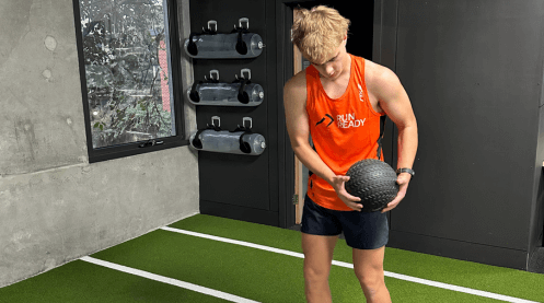 Strength training, Melbourne strength and conditioning, Melbourne S&C, Melbourne strength and conditioning coach, strength trainer, Man holding medicine ball in gym - Run Ready