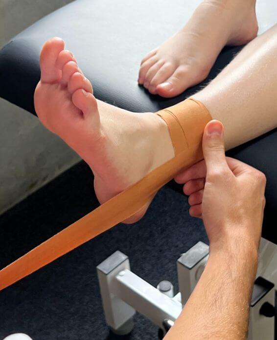 ankle sprain, running injury, sports physio for runners, Richie Lynch taping ankle and foot