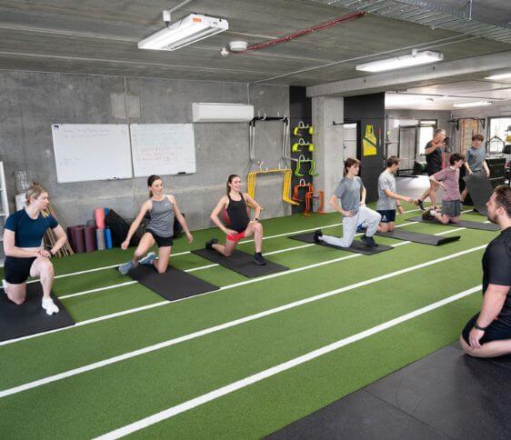 athletics coaching, athlete training, strength and conditioning Melbourne, S&C Melbourne, strength coach Melbourne, group of athletes training in gym