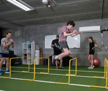hurdle jumps in gym, athletes doing hurdle jump exercises, strength coaching, strength coach, run coach for athletes, Melbourne strength coach, run coaching